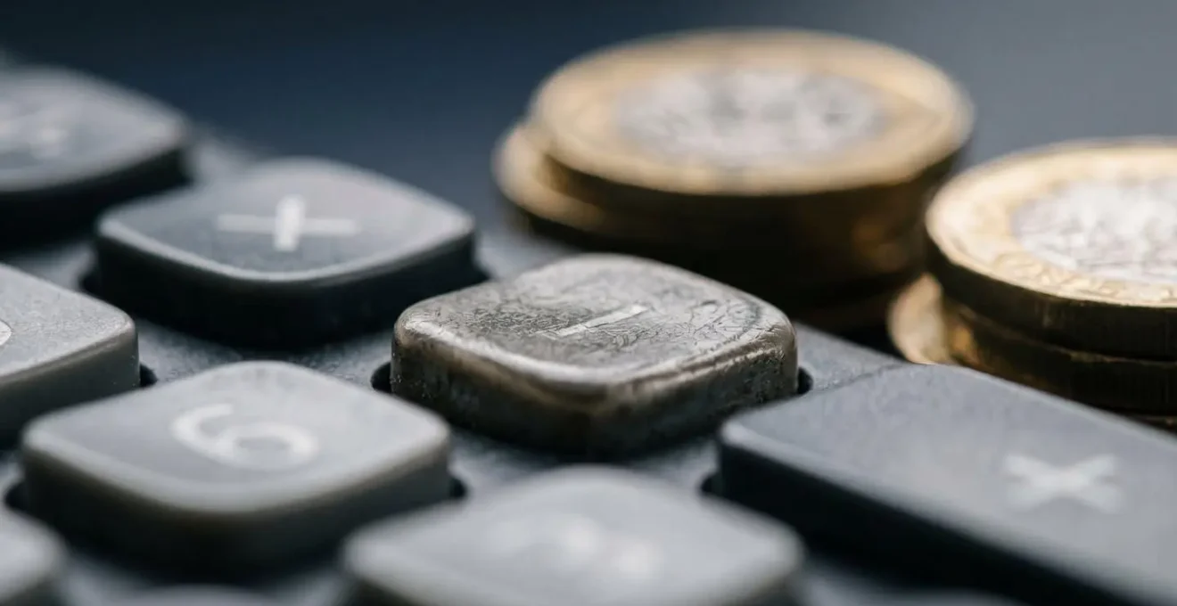 Macro shot of calculator keys and British currency showing financial calculation precision